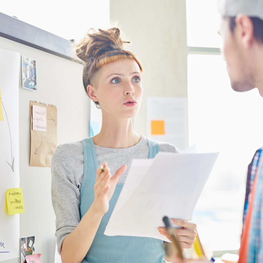 image of white female presenting idea to a male in a meeting